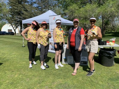 An enthusiastic golf team shows their support and their style. 