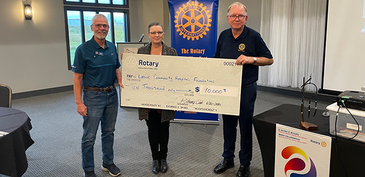 Rotarians Grant Leach and Kasey Kozicky present Foundation Executive Directory Colleen Zimmerman with cheque for $10,000