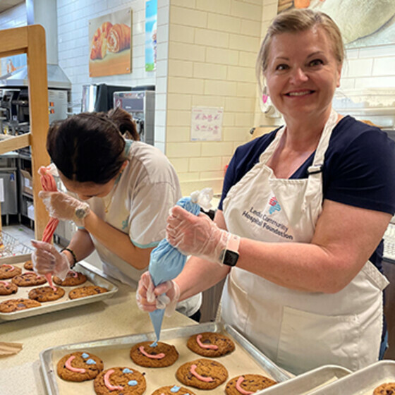 A Foundation volunteer decorating Tim Hortons Smile Cookies